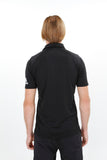 Back of a man wearing black recycled bermuda polo with adidas logo on the left arm