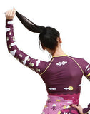 Fit brown haired women wearing Trio Sports Trashee Rashguard made from Recycled Ocean Waste